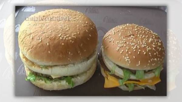 Two double cheeseburgers are shown next to each other. The one on the left is much larger than the one on the right.